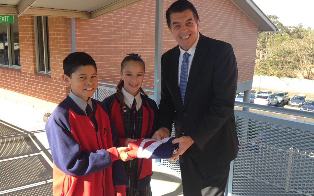 Presenting the State Flag to Castle Hill Primary School Leaders Manu and Natalie